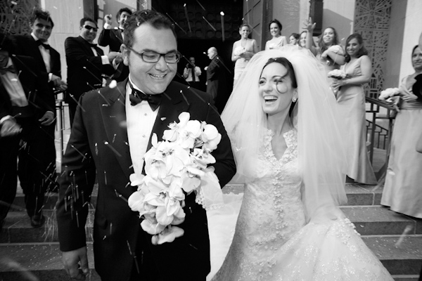 photo by New York based wedding photographer Merri Cry - black and white photo of the bride and groom exiting the ceremony 